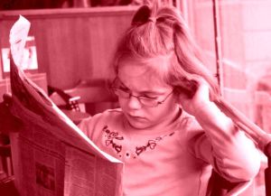 girl reading paper 